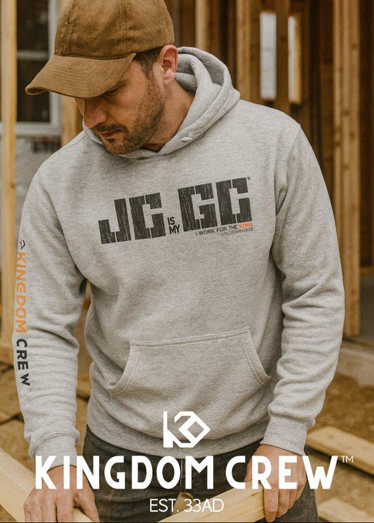 Man wearing a gray hoodie with 'Kingdom Crew' branding in a construction setting.