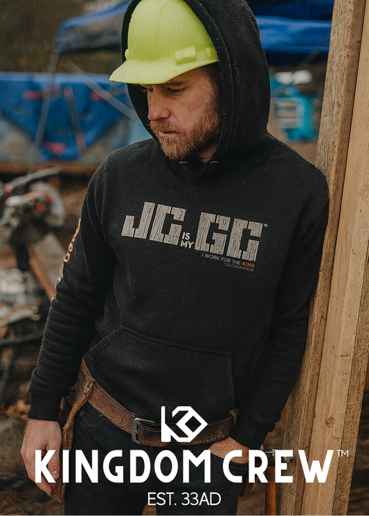 Man wearing a black hoodie with 'Kingdom Crew' branding in an outdoor setting.
