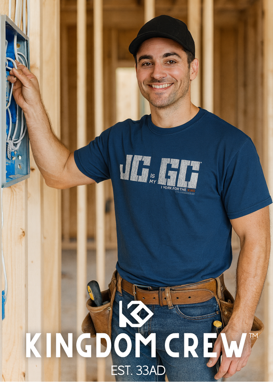Man in a blue t-shirt with 'Kingdom Crew' logo in a construction setting