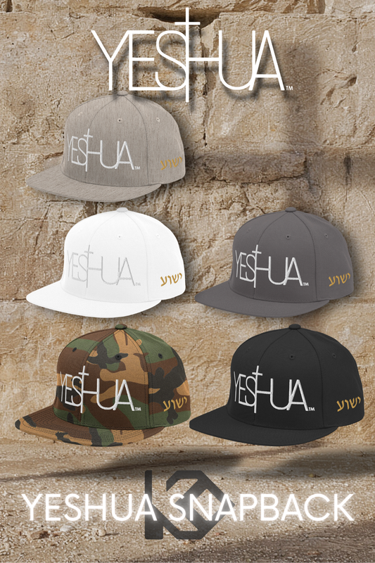 Five Yeshua snapback caps in different colors on a stone wall background.