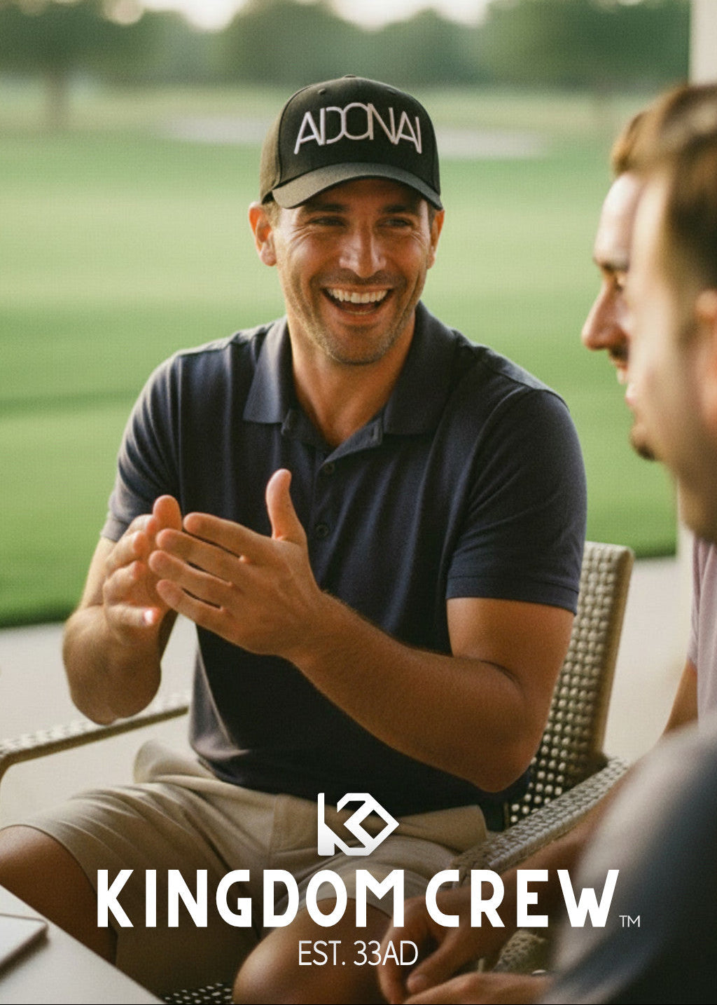 Two men sitting outdoors with a golf course in the background, featuring the Kingdom Crew logo.