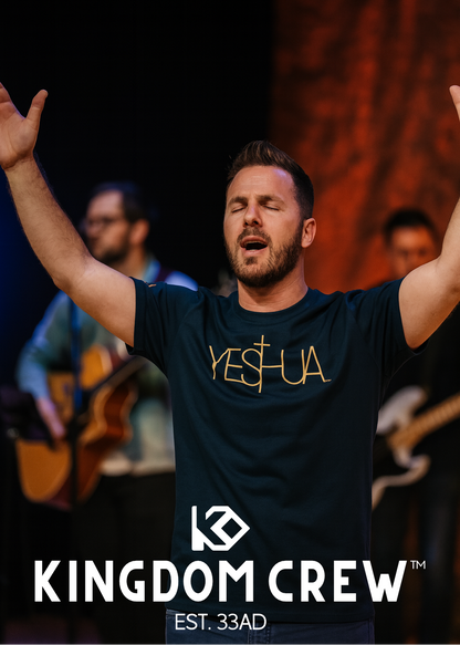 Man with arms raised wearing a 'YESHUA' shirt with Kingdom Crew branding.