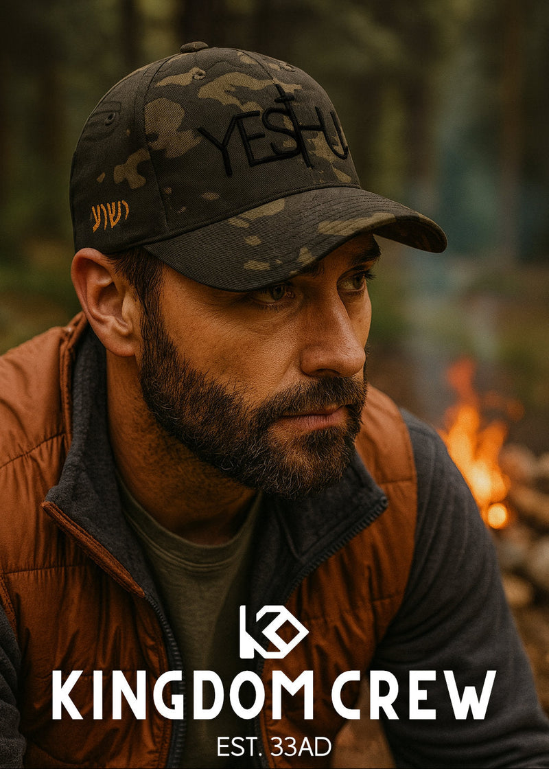Man wearing a cap with 'YESHUA' and 'KINGDOM CREW' branding in a forest setting.